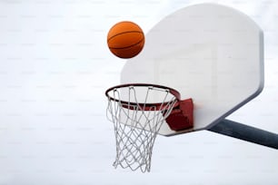 a basketball going through the hoop of a basketball hoop