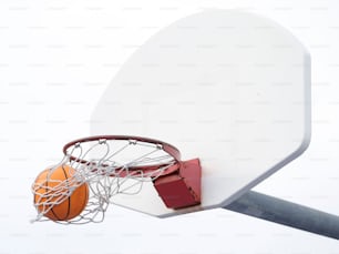 a basketball going through a hoop with a basketball in it