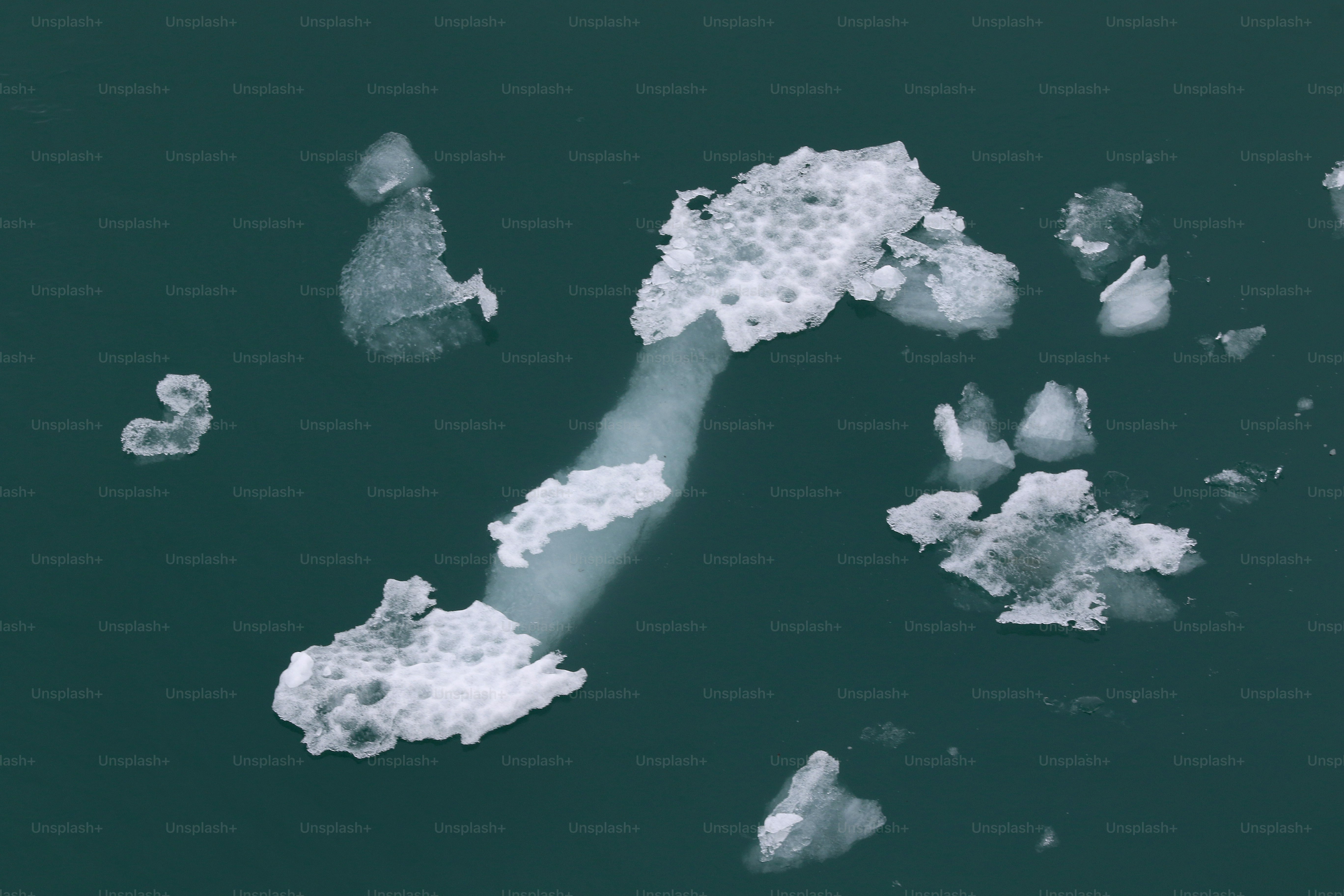 an aerial view of ice floes floating in the water