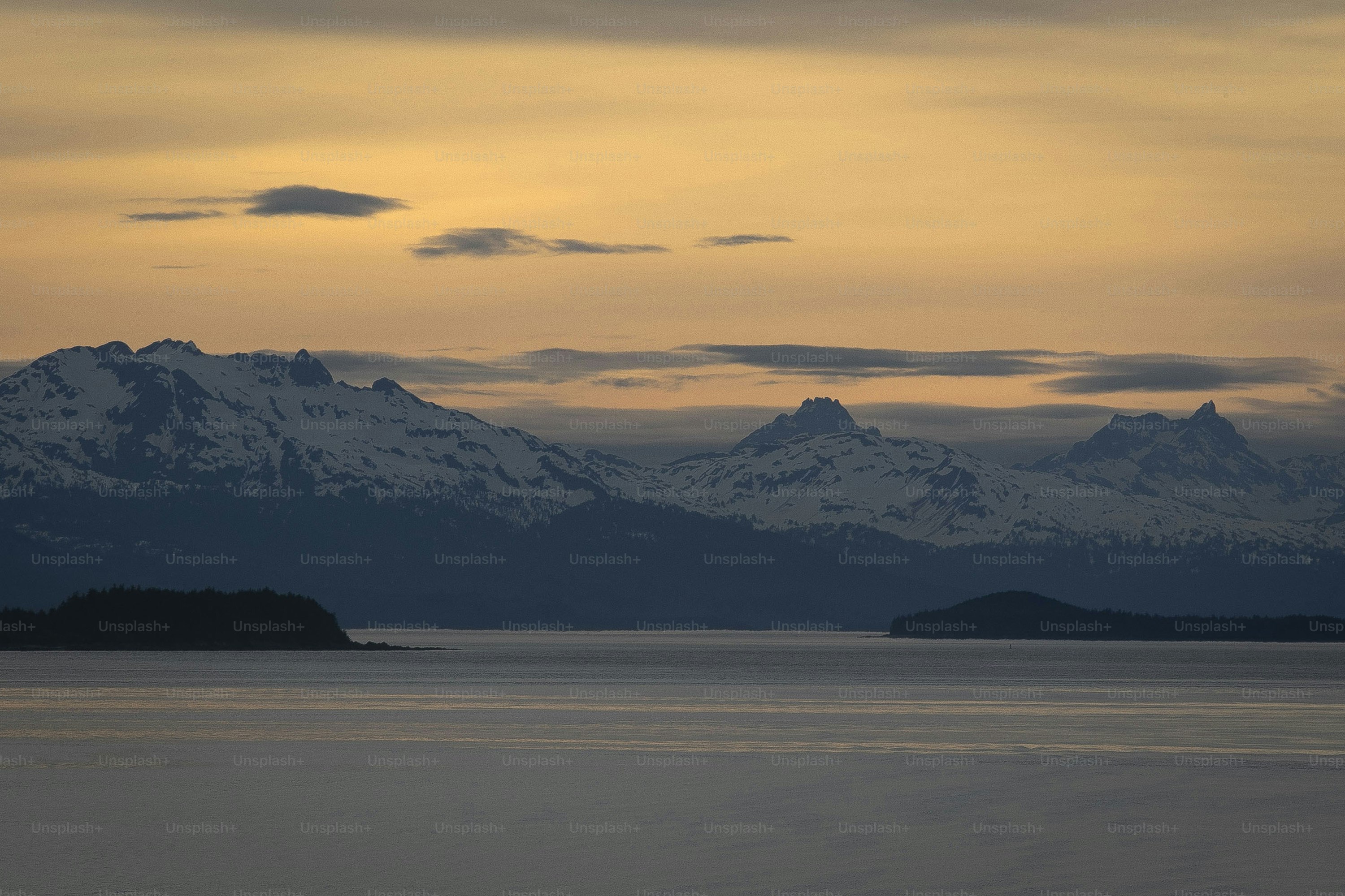 a large body of water with mountains in the background