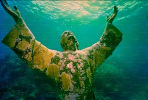 a statue of a man under the water