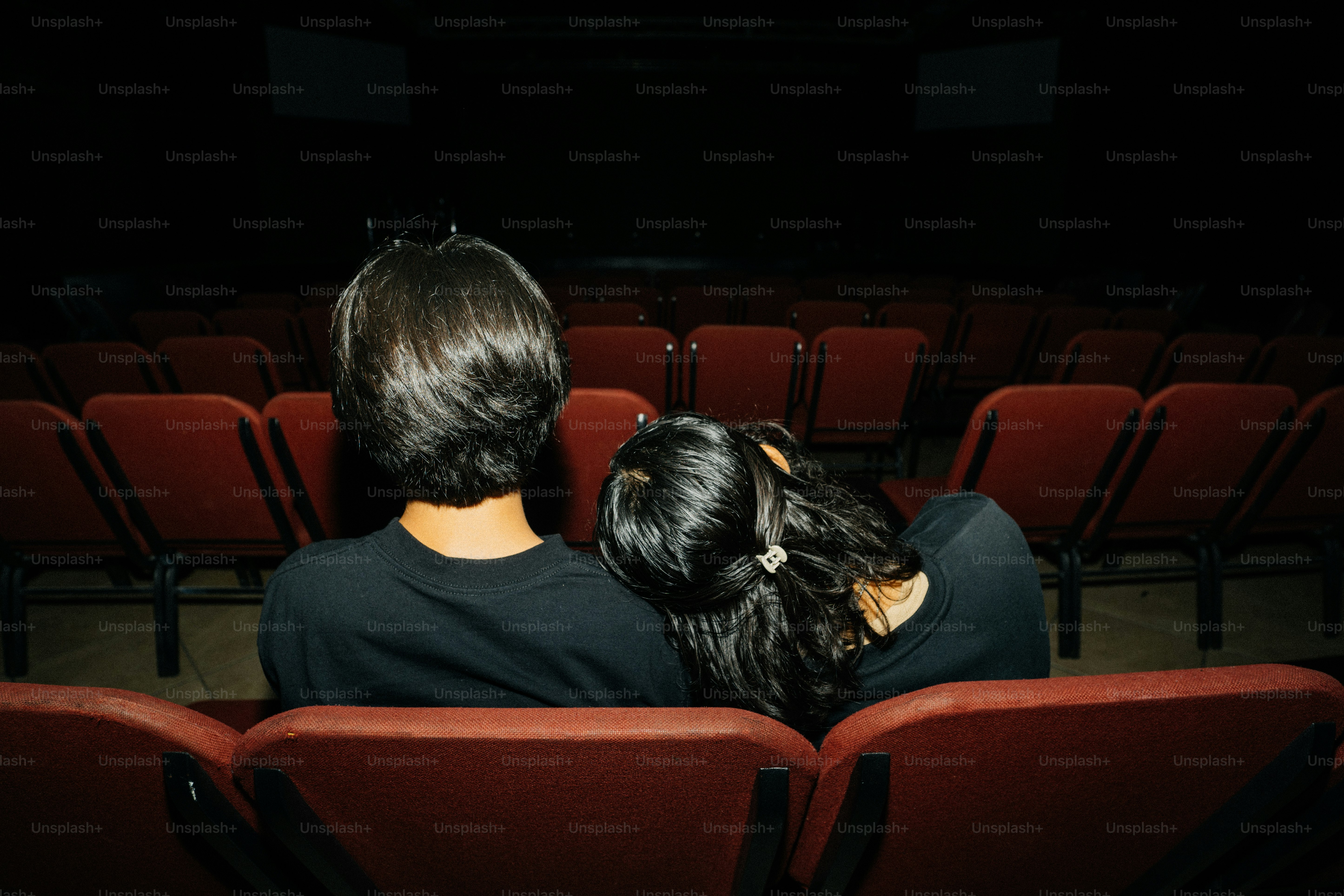 a couple of people sitting in a theater