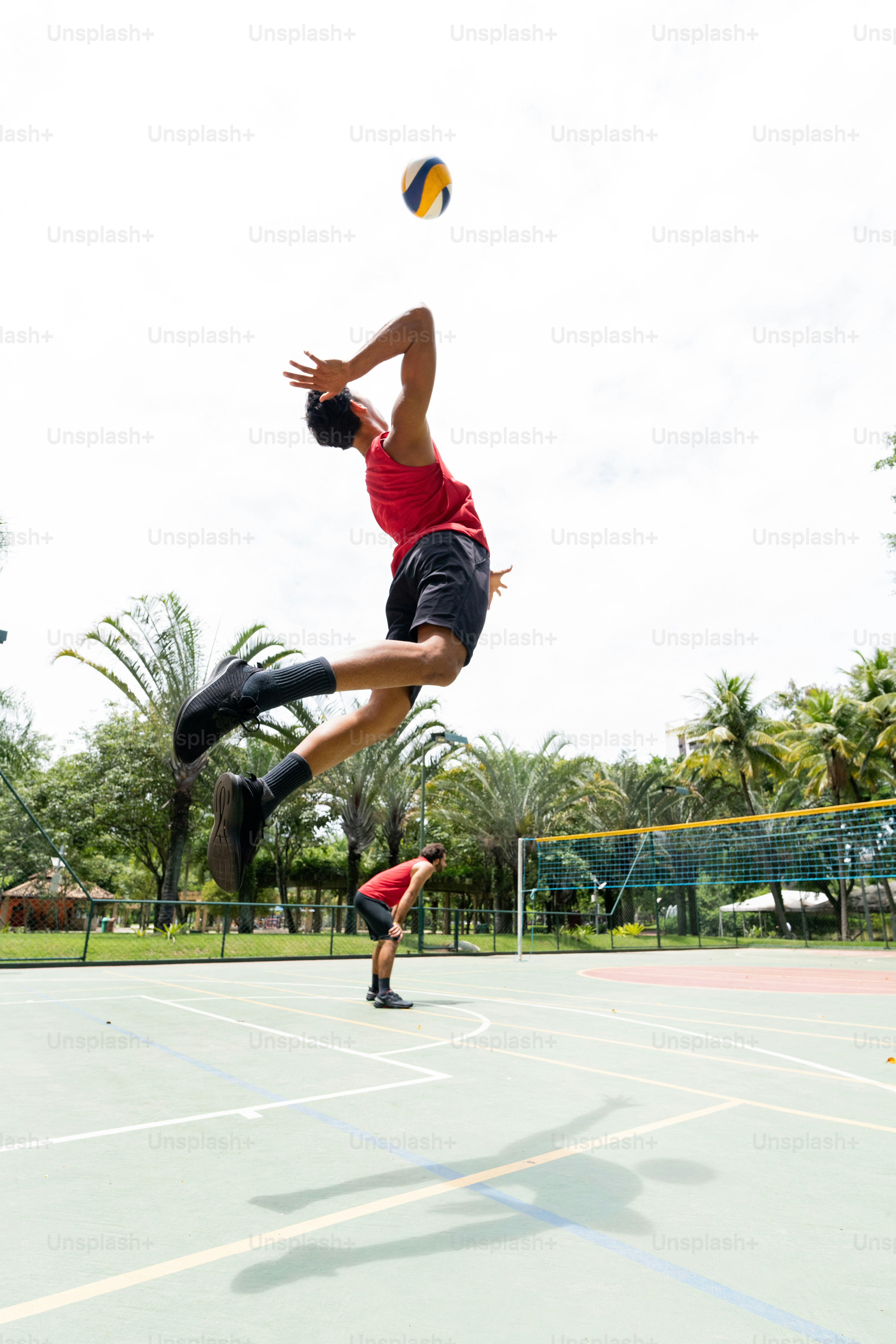 a man jumping in the air to catch a frisbee