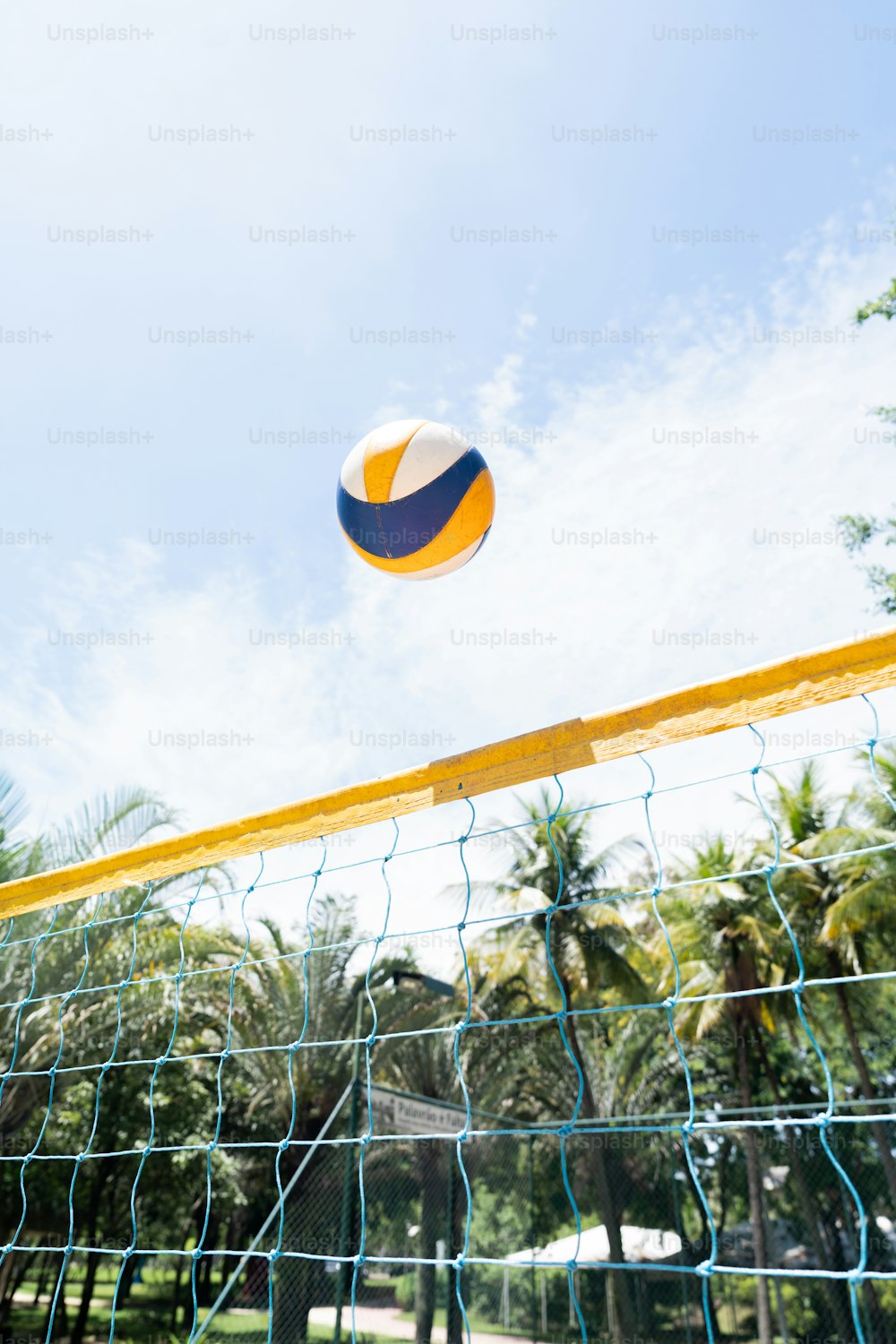 a volleyball is hitting the ball over the net