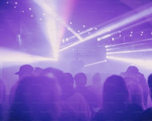 a crowd of people standing around a stage