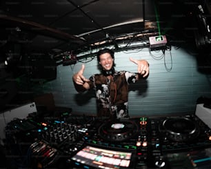 a man standing in front of a mixing desk