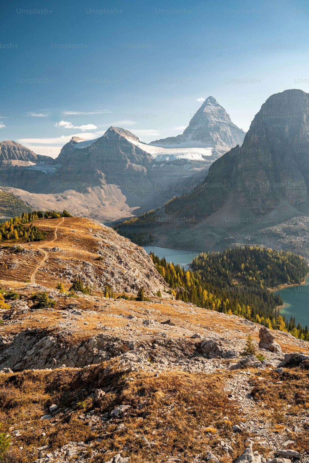 a view of a mountain range with a lake in the foreground