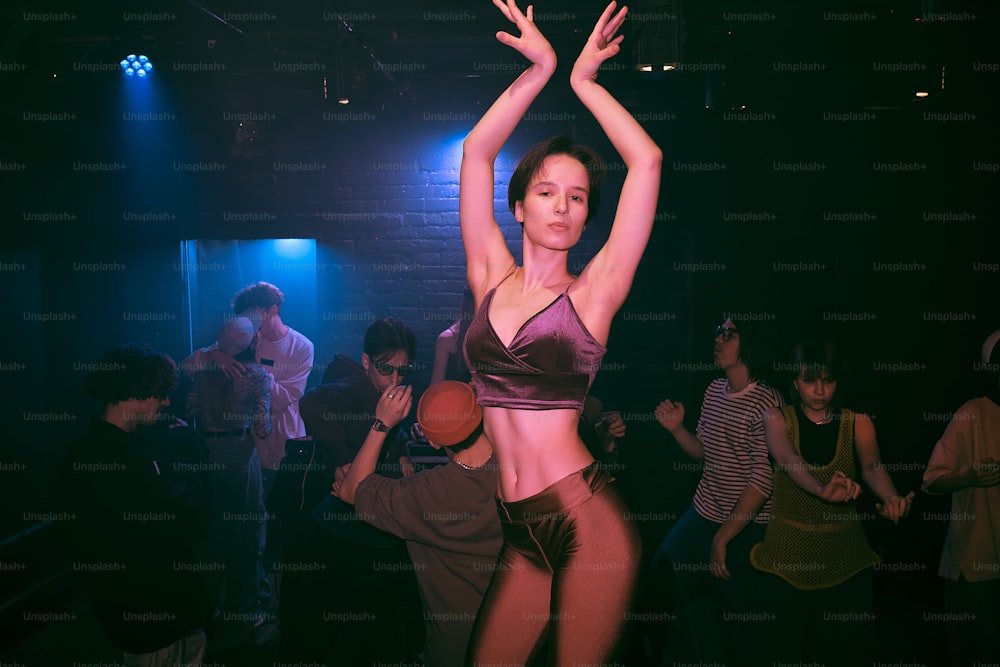 a woman in a bikini top dancing in a club