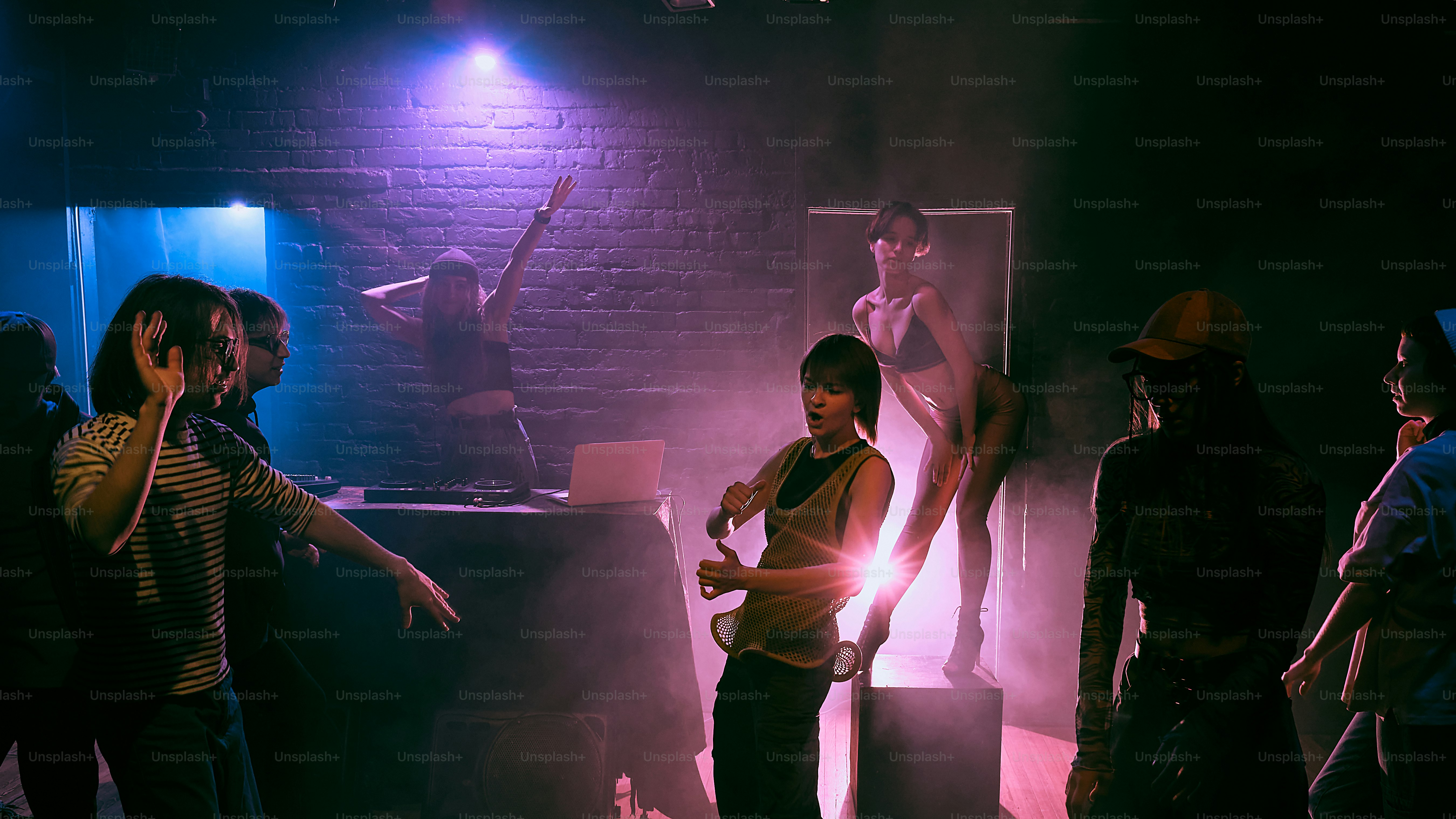 A group of people standing around in a room photo – Music Image on Unsplash