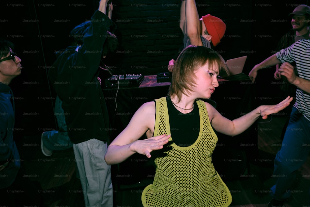 a group of people dancing in a dark room