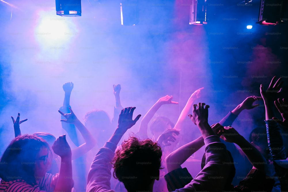 a group of people standing in front of a stage