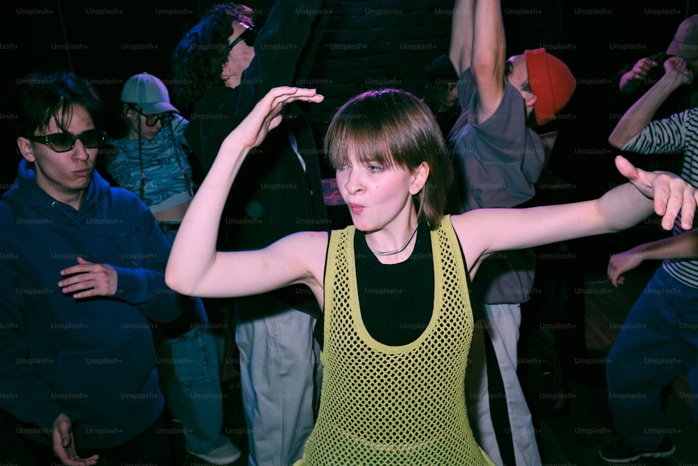 a woman in a yellow top is dancing