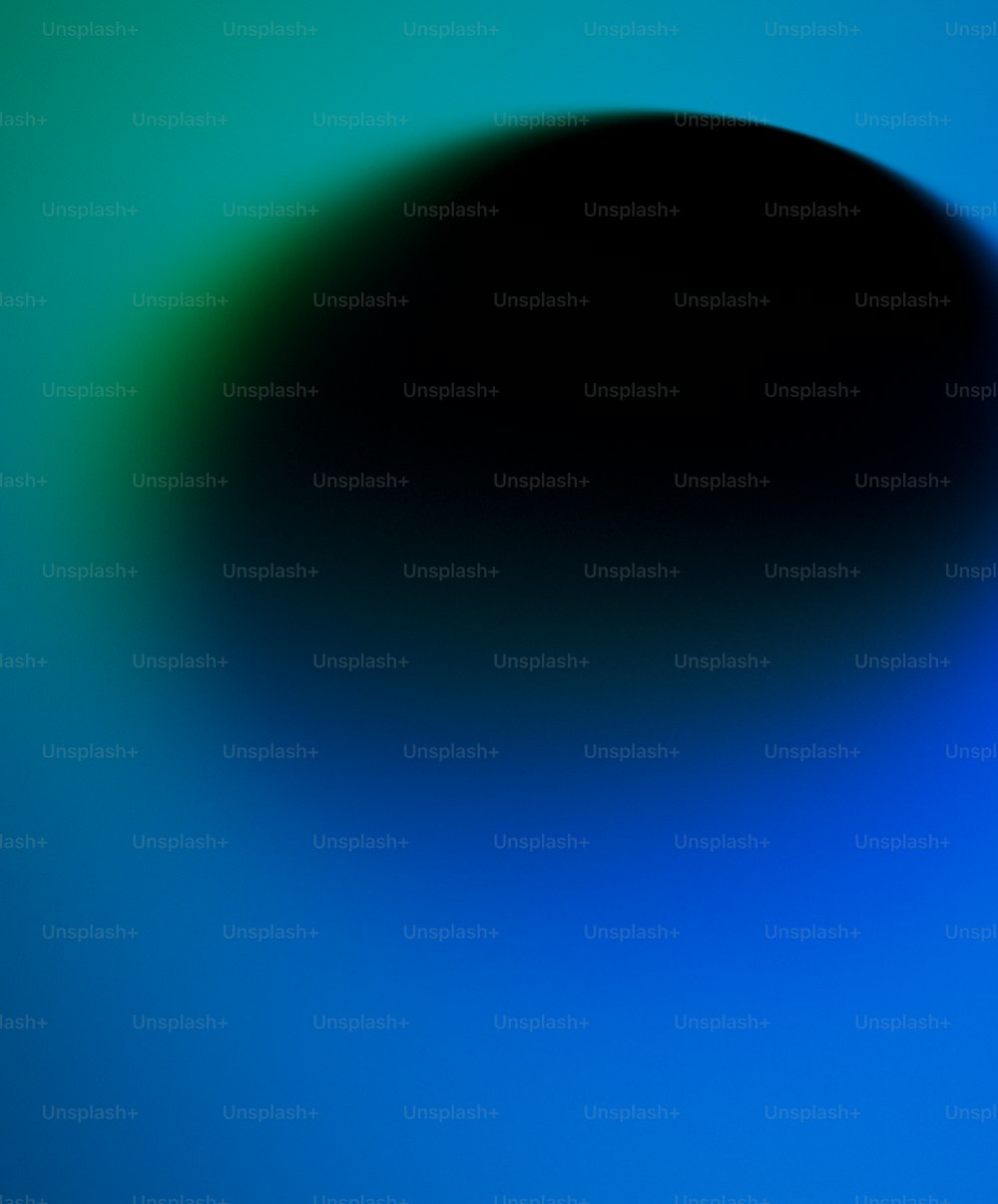 a black object on a blue and green background