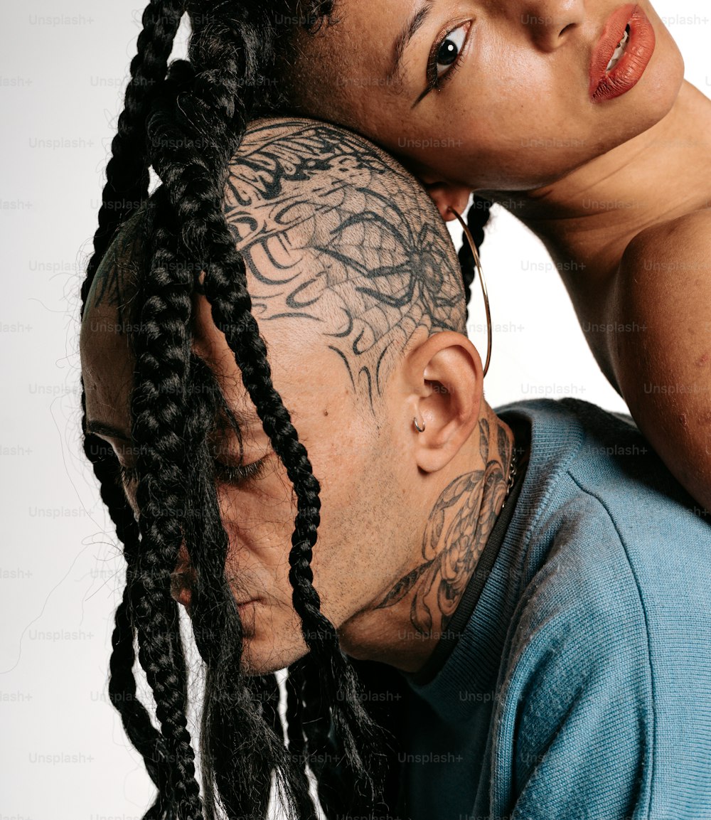 um homem e uma mulher com tatuagens na cabeça