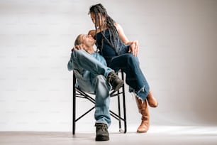 a man and a woman sitting on a chair