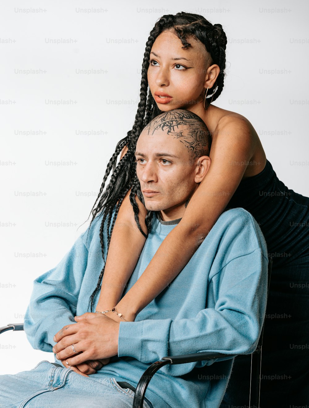 a woman sitting on a man's lap with a bald head