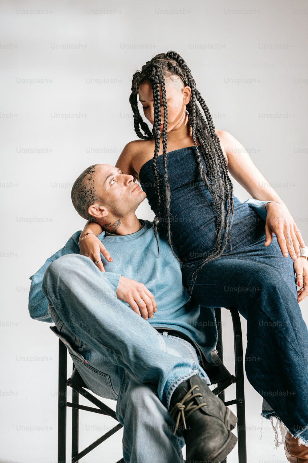 a man sitting on a chair next to a woman