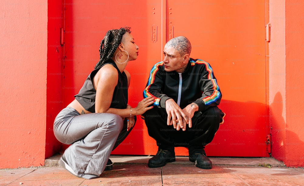 a man and a woman sitting on the ground