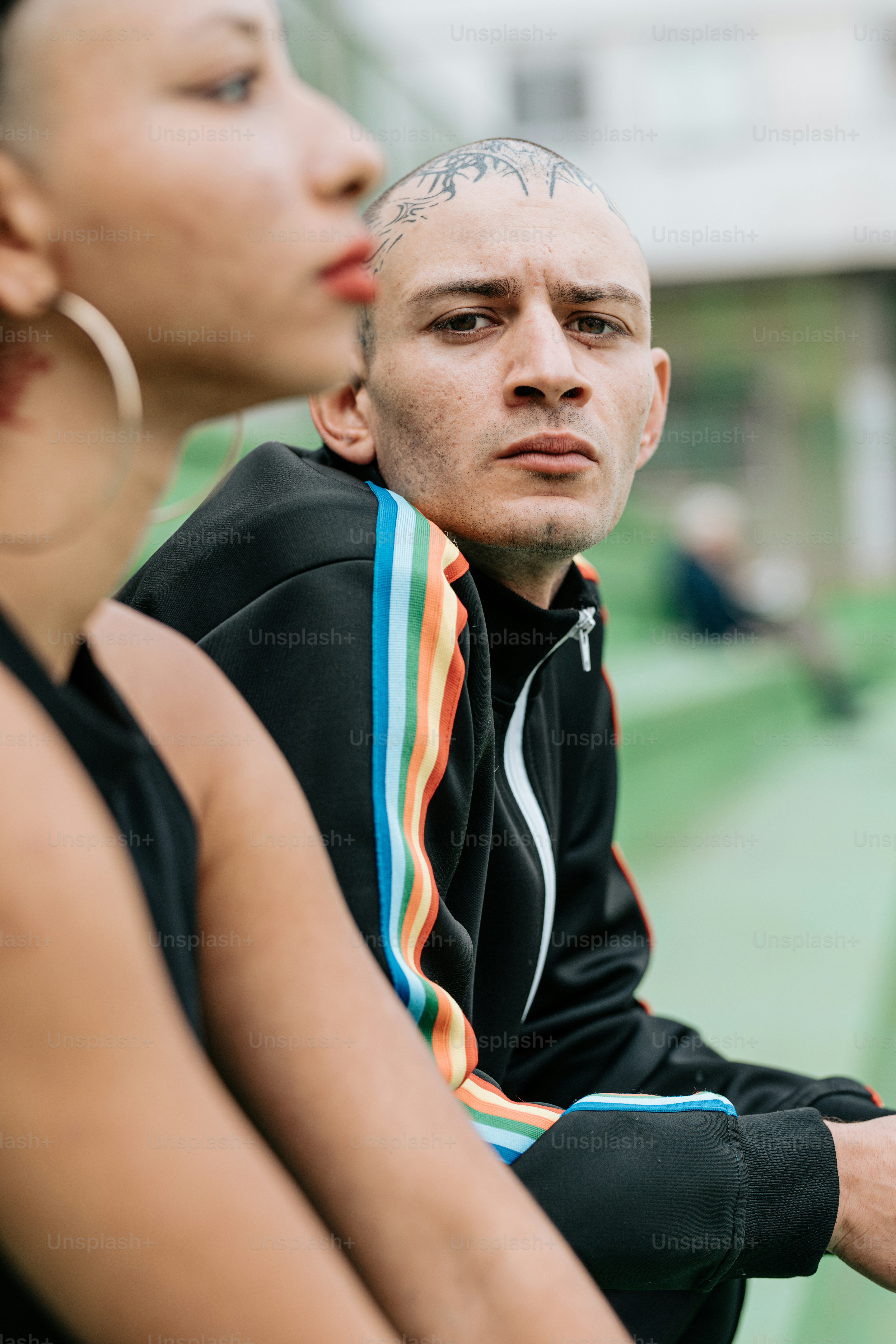 a man and a woman sitting on a tennis court