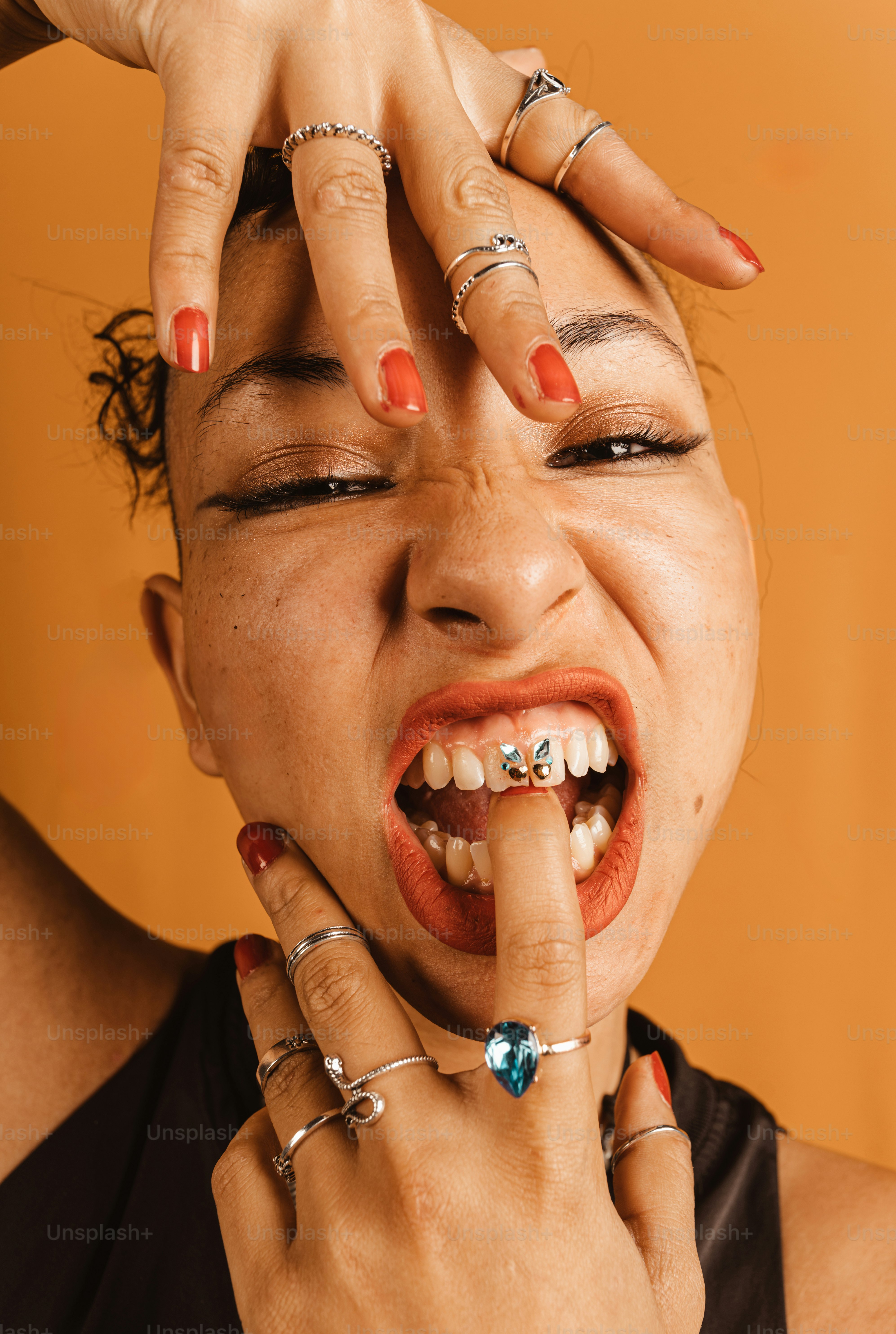 a woman holding her finger up to her mouth