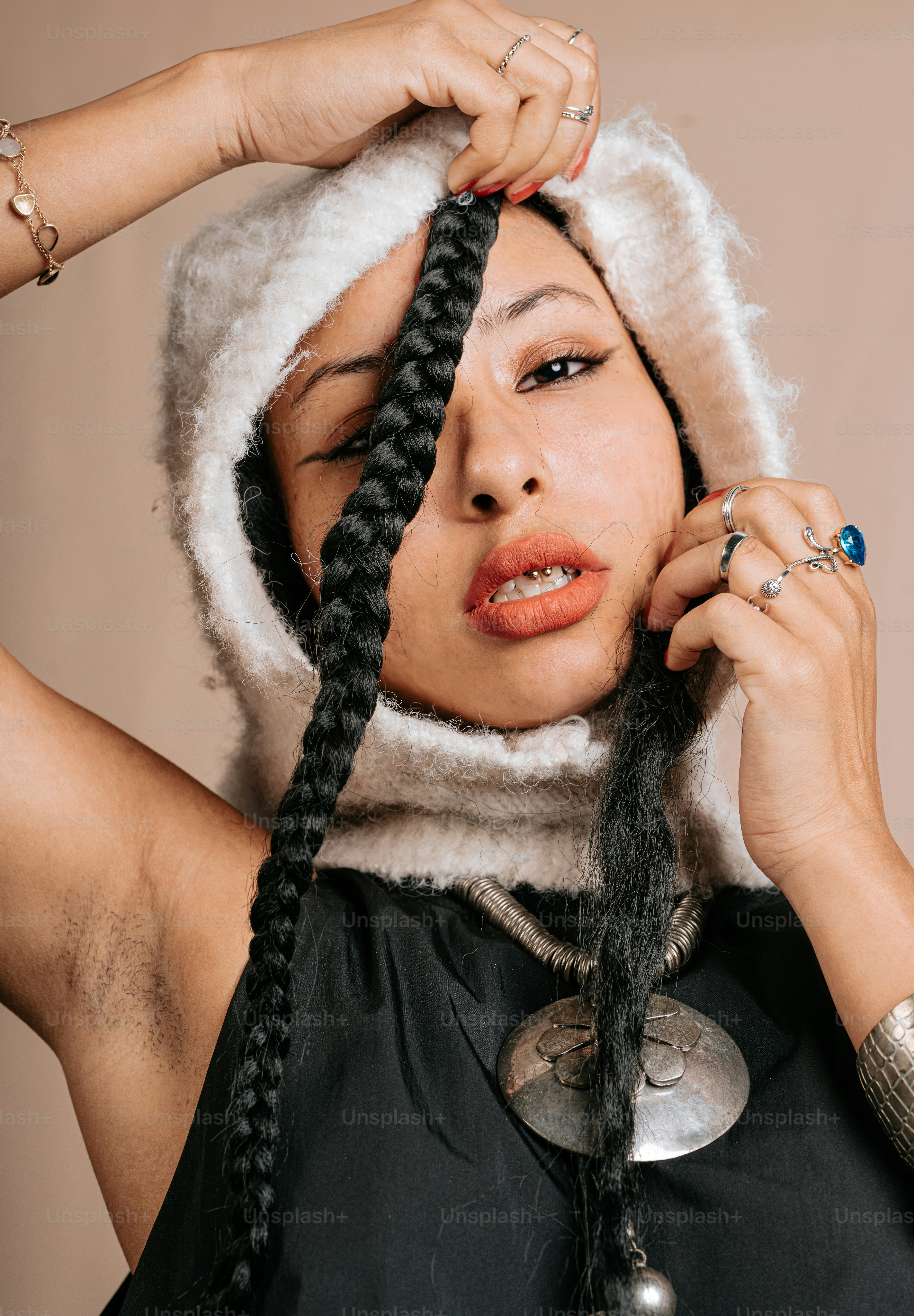 a woman with braids on her head and a hood