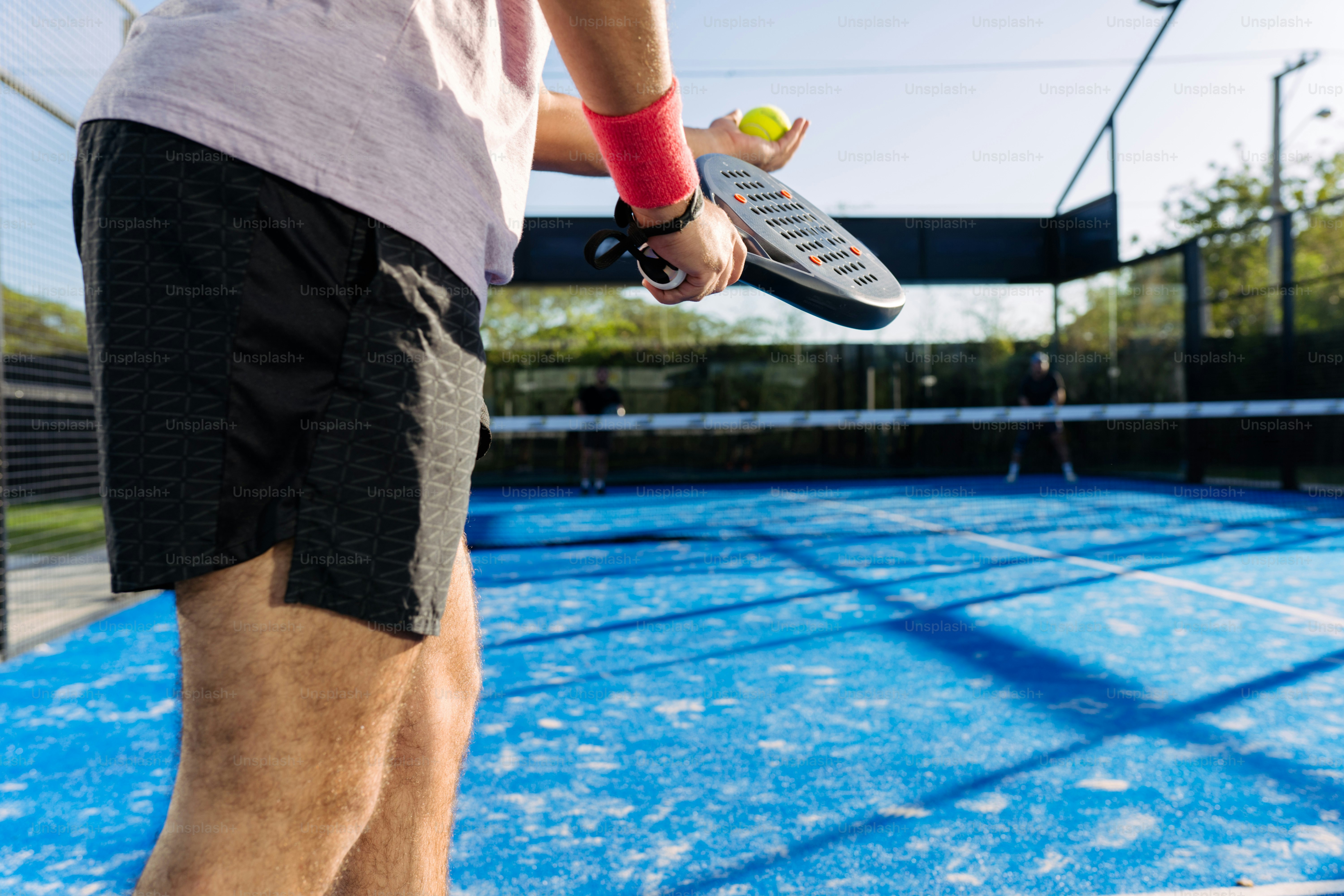 a man holding a tennis racket and a tennis ball