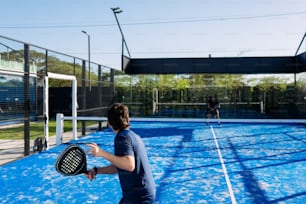 a man holding a tennis racquet on top of a tennis court