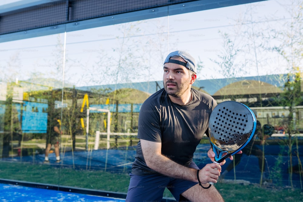 a man holding a tennis racquet on top of a tennis court