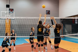 a group of young women playing a game of volleyball