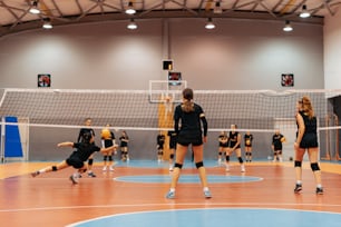 a group of women playing volleyball on a court