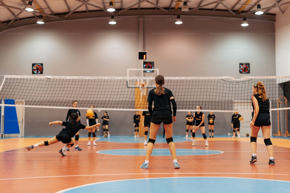 a group of women playing volleyball on a court