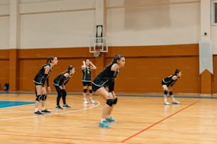 a group of young women playing a game of volleyball