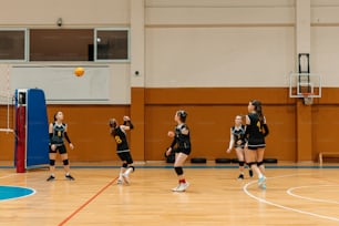a group of girls playing a game of volleyball