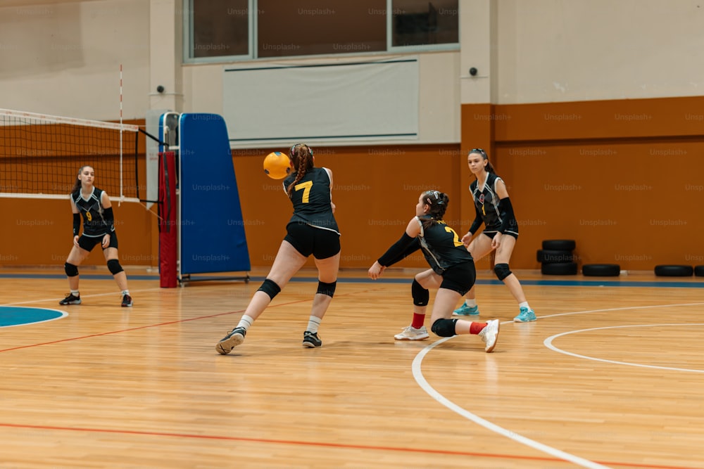 a group of young women playing a game of volleyball