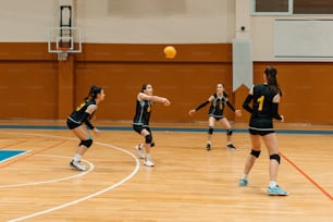 a group of young women playing a game of volleyball