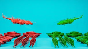 a group of green and red models of military vehicles
