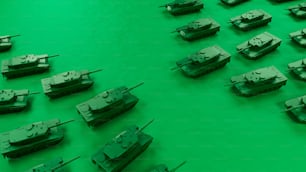a bunch of tanks that are on a green surface