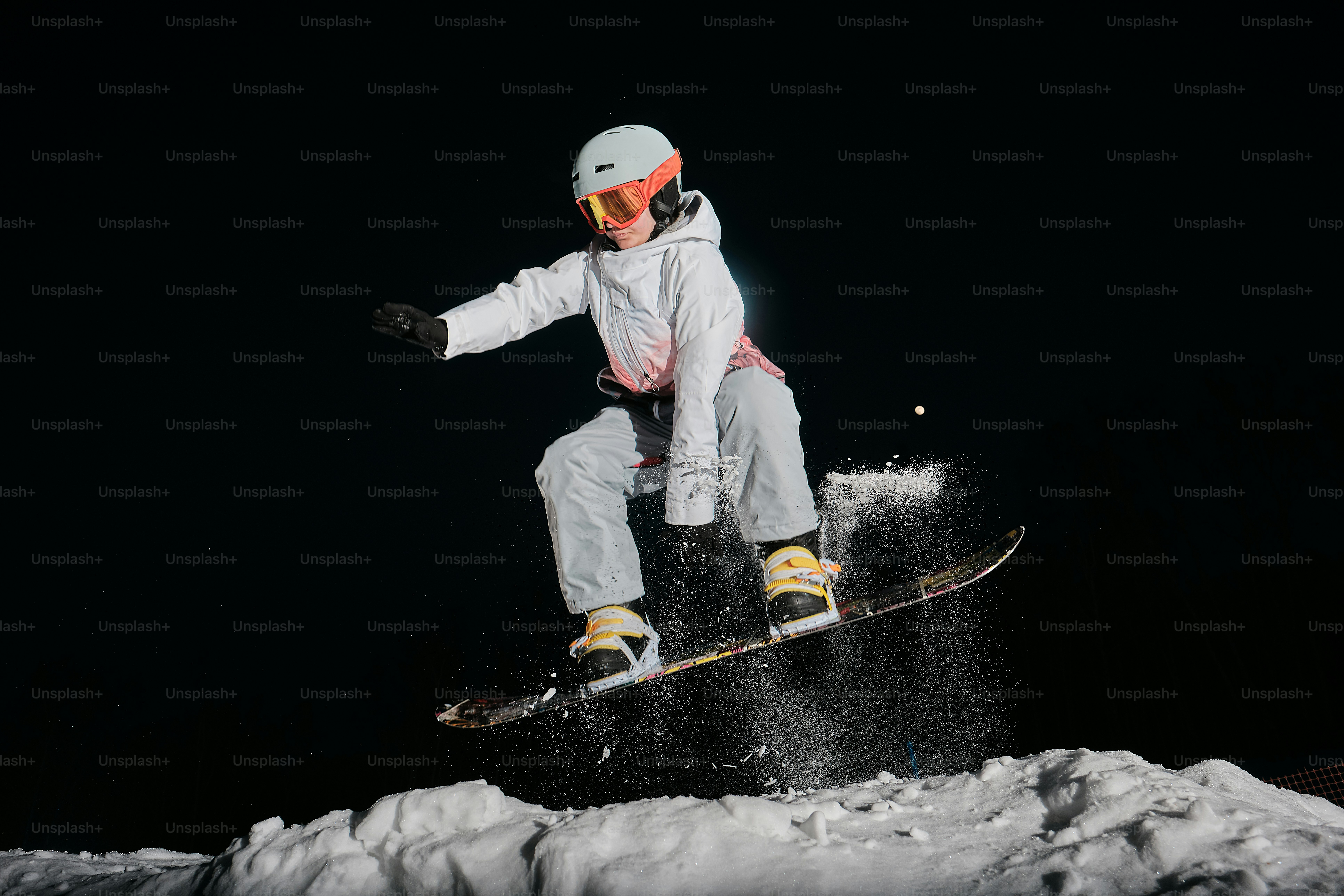 a person on a snowboard jumping in the air