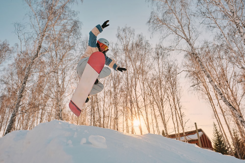 a snowboarder is doing a trick in the air