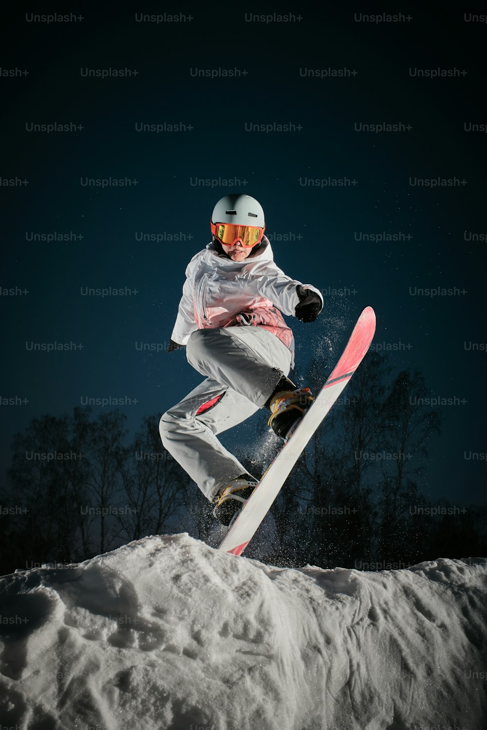 a person on a snowboard jumping in the air