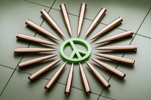 a peace sign made out of copper bullet heads