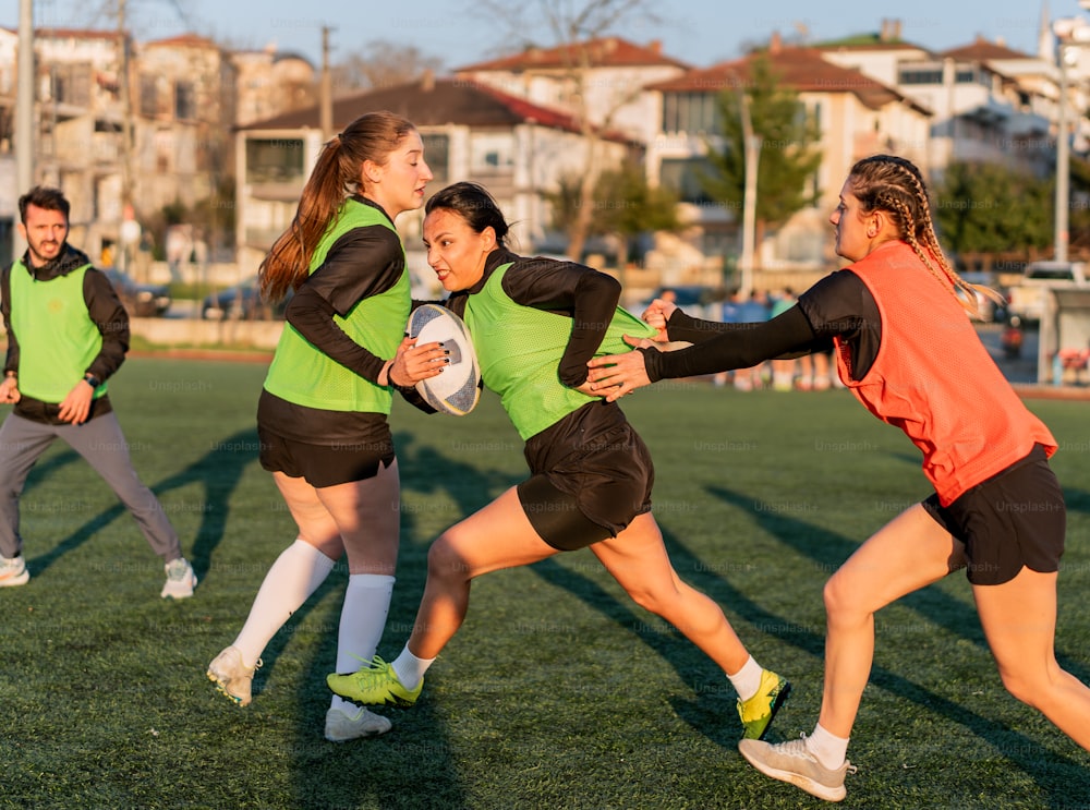 a group of young women playing a game of frisbee