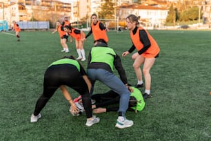 a group of women in orange shirts playing soccer