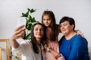 a woman taking a picture with her two daughters