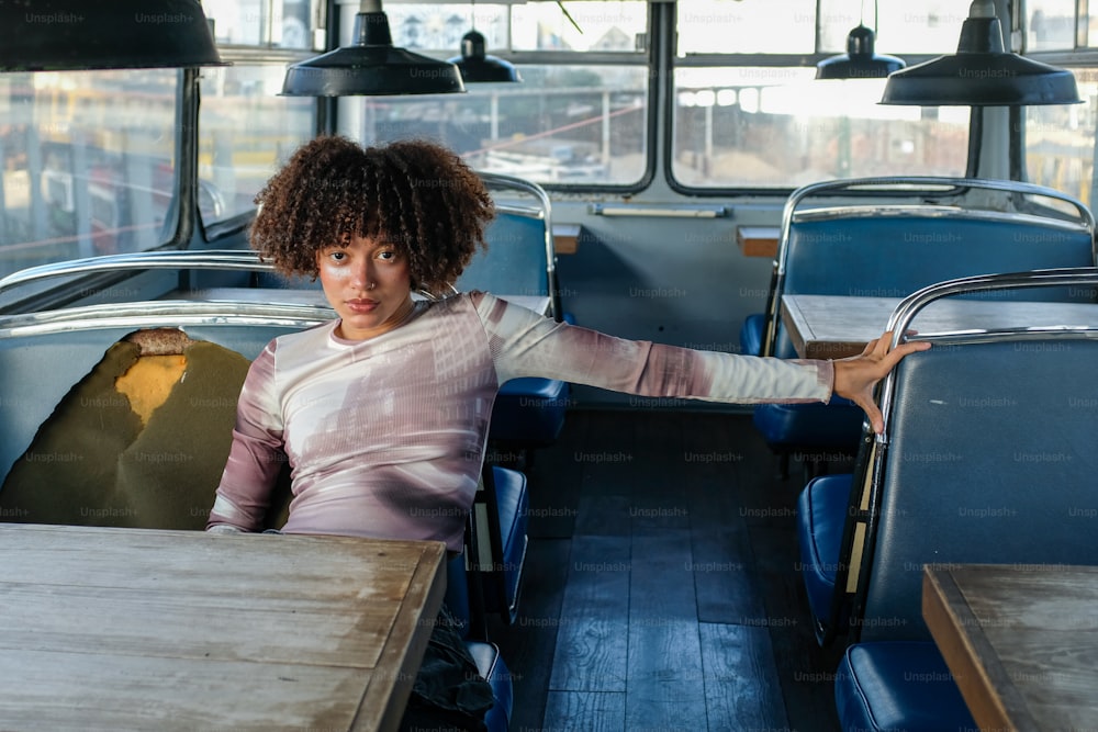 a woman sitting at a table in a bus