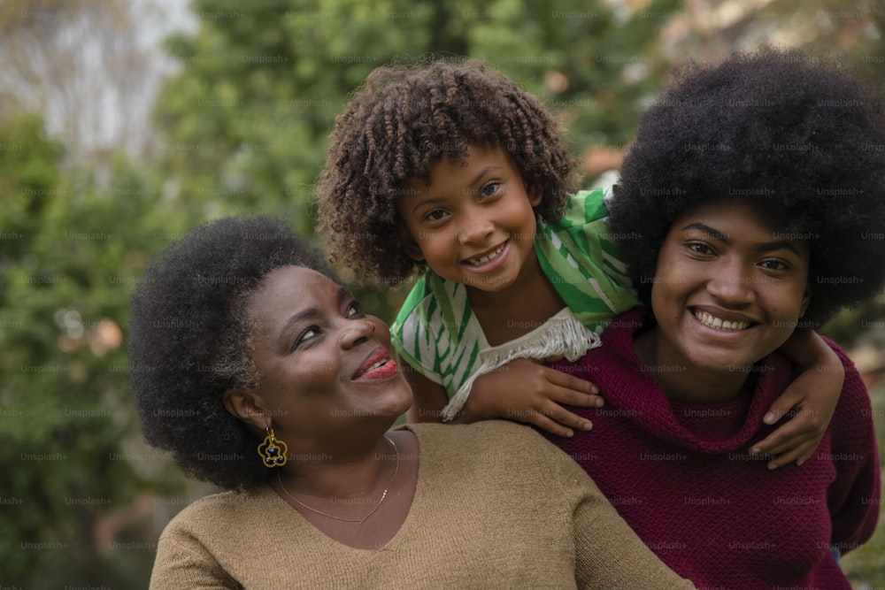 two women and a child are smiling for the camera