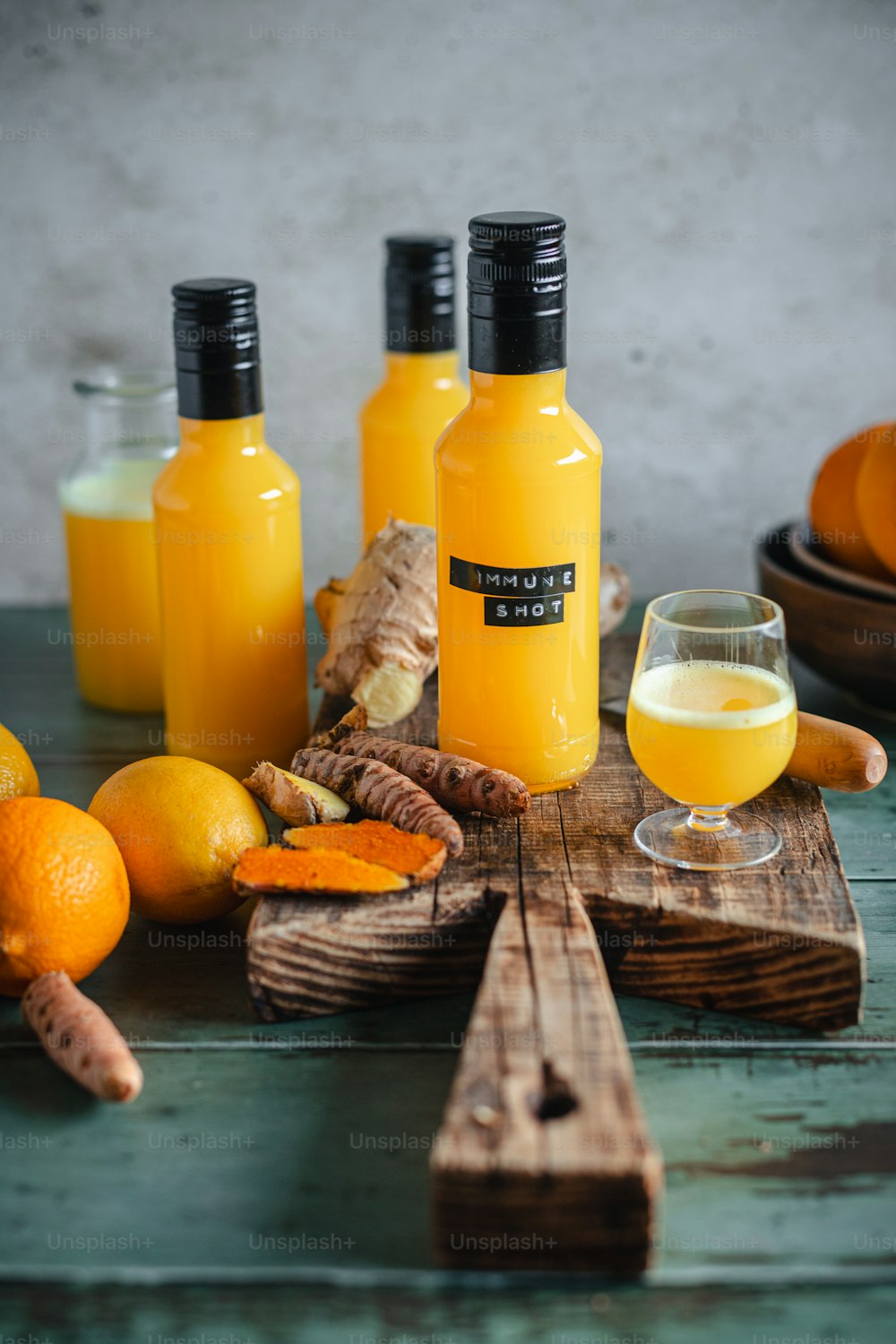 a table topped with bottles of orange juice