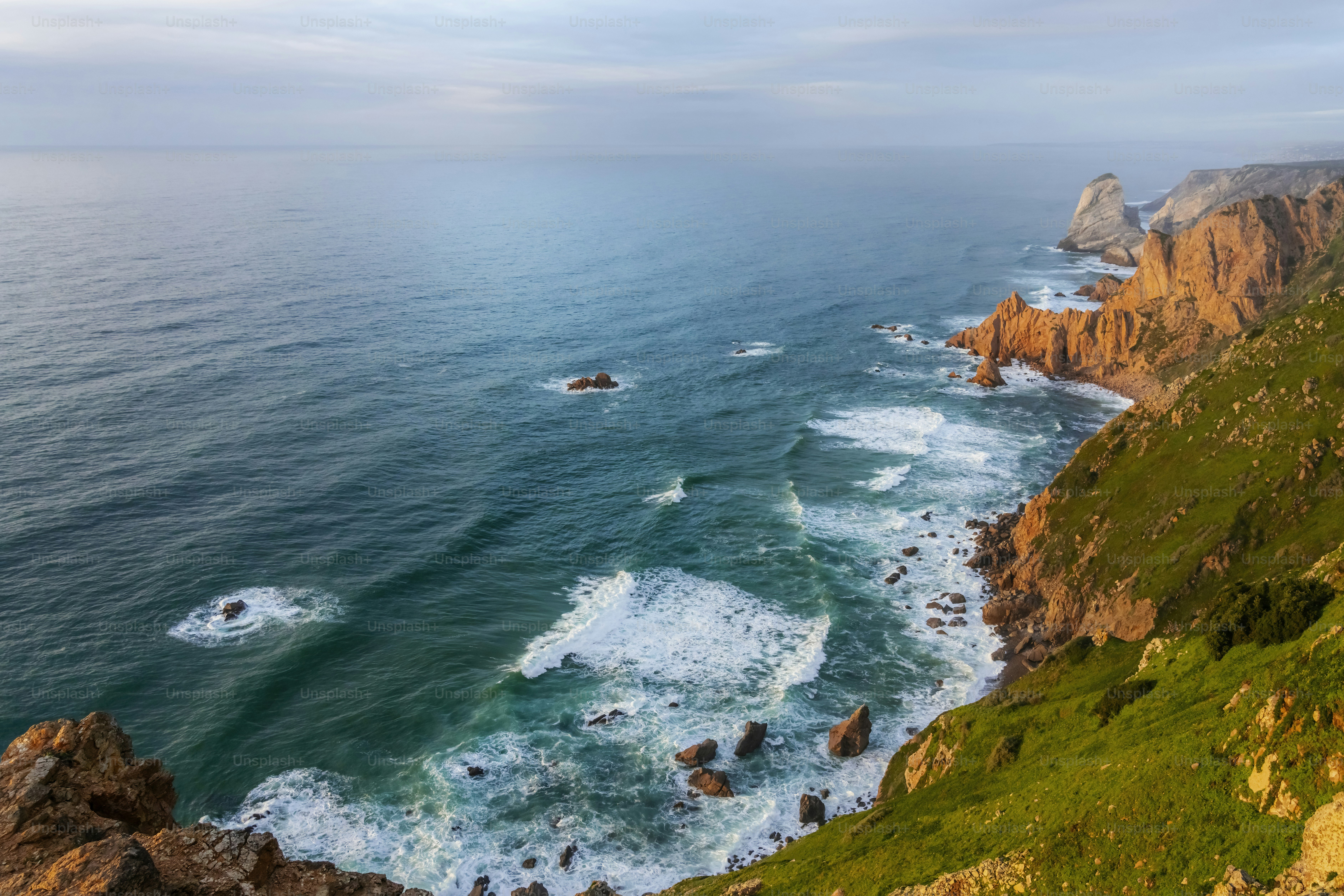 a view of the ocean from the top of a hill