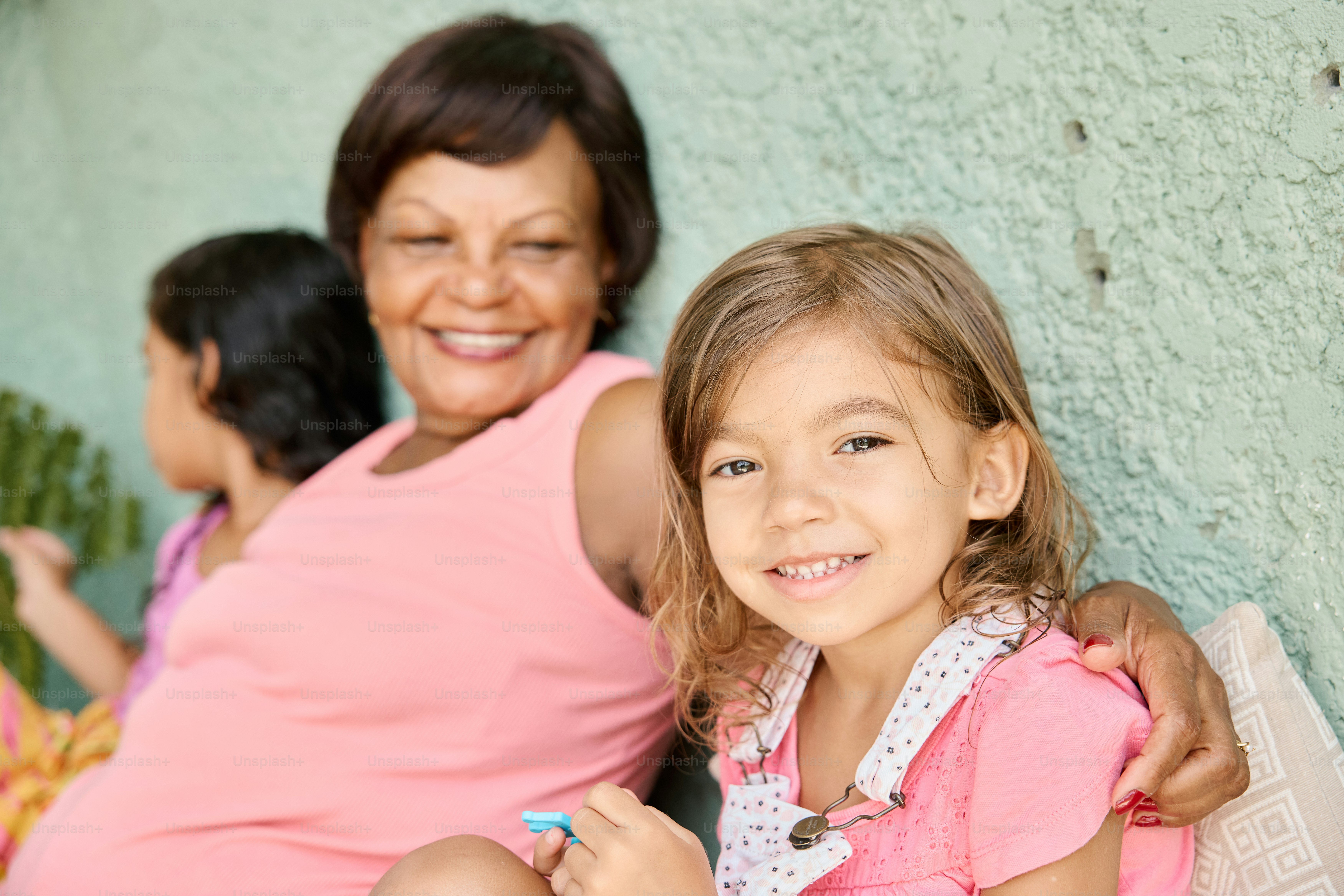 a woman and a little girl sitting next to each other