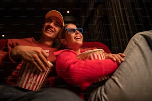 a man and a woman sitting in a movie theater